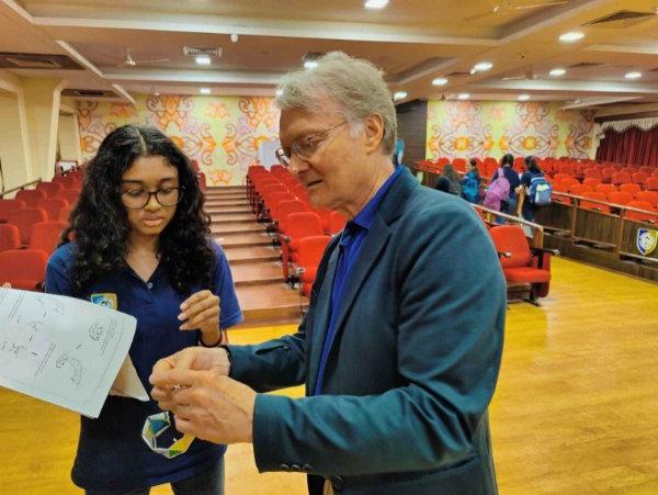 Mark Staves shows a DNA paper to a student in India