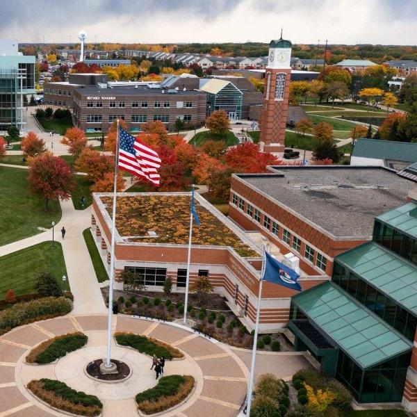 drone photo of Allendale Campus with flag circle at bottom right and carillon tower in upper left